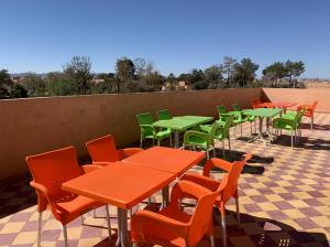 a row of tables and chairs on a patio at Tinejdad Auberge in Tinejdad