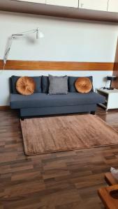 a blue couch with two pillows in a living room at Residenza 404 in Ivrea