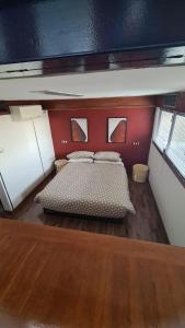 a bedroom with a bed in a room with red walls at Residenza 404 in Ivrea