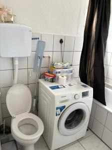 a bathroom with a washing machine and a toilet at Sweet home Jagodina in Jagodina