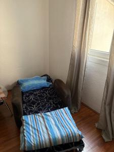 a small room with a bed and a window at Sweet home Jagodina in Jagodina
