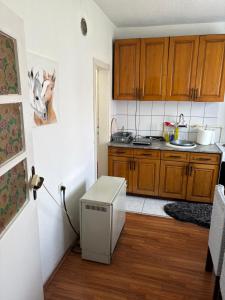 a kitchen with wooden cabinets and a heater in a room at Sweet home Jagodina in Jagodina +6 photos