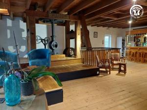 a living room with blue chairs and a table at Le Moulin d'Audenfort in Clerques