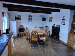 a kitchen and dining room with a table and chairs at Gerry's house in Milltown Malbay +3 photos