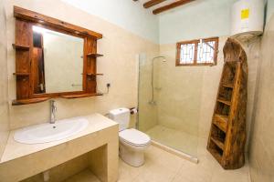 a bathroom with a sink and a toilet and a shower at Majani Breeze Zanzibar in Nungwi +40 photos