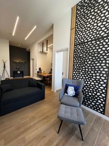 a living room with a couch and a chair at APART_SANVICENTE 6 in Vigo