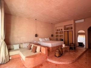 a large bedroom with a bed and a couch at Le Bohémien Suites Cabana in Dalung