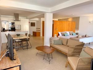 a living room with a bed and a couch and a kitchen at Ocean Suite by SHC with heated pool only for adults in Telde