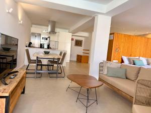 a living room with a couch and a table at Ocean Suite by SHC with heated pool only for adults in Telde
