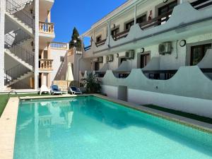 a swimming pool in front of a building at Don Carlos in Paguera