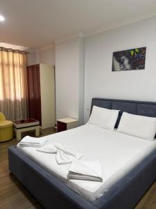 a bedroom with a large bed with white sheets at Ikea hotel in Kashari