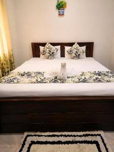 a bed with white sheets and pillows on it at Udara Guest - Yala Safari in Yala