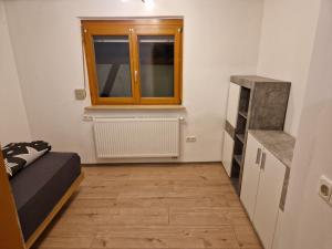 a small room with a bed and a window at Herzstück in Grafenrheinfeld