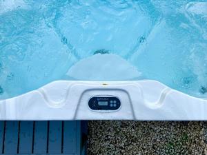 a swimming pool with a thermometer in the water at Como - Magic Garden House - Lake View in Como