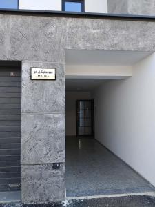 an empty hallway with a sign on the side of a building at Apartment Moni 3 in Veliko Tŭrnovo