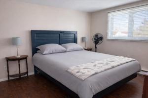 a bedroom with a large bed and a window at Wild Cove Cabin in Twillingate