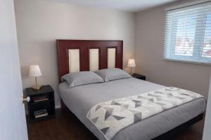 a bedroom with a large bed and a window at Wild Cove Cabin in Twillingate
