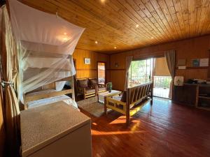 a bedroom with bunk beds and a living room at Nhucha Villas in Santa Maria