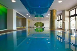 a pool in a hotel with a blue ceiling at Kipriotis Panorama Hotel & Suites by Anayia All Inclusive Resorts in Kos