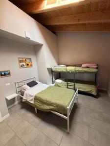 a bedroom with two beds and a wooden ceiling at Polly house in Lodi