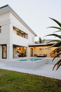 a house with a swimming pool in front of it at Salt & Feather in Yzerfontein