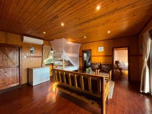 a living room with a bench and a room with a bed at Nhucha Villas in Santa Maria +37 photos
