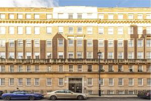 a large building with cars parked in front of it at London Central Residence in London