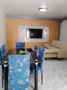 a living room with a table and chairs and a couch at Candava's Residence in Puerto Galera