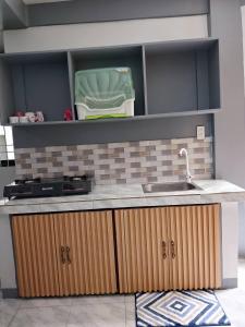 a kitchen with a sink and a counter top at Candava's Residence in Puerto Galera