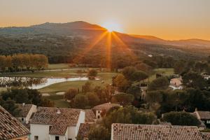 a view of a residential neighborhood with the sun setting at Village Pierre & Vacances Pont Royal en Provence in Mallemort