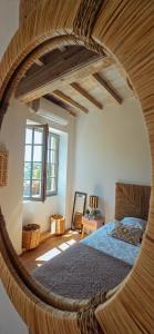 a bedroom with a large bed with a wooden frame at LE CLOS ZÉLIE in Pouilly-le-Monial