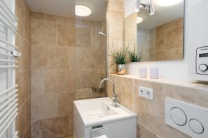 a bathroom with a sink and a mirror at Braderuper Heide in Braderup +13 photos