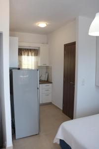 a kitchen with a refrigerator in a room at Ateni House Garden in Agios Petros