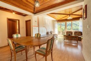 a dining room with a wooden table and chairs at Apartmaji Loretica in Most na Soči