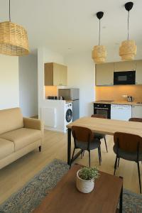 a living room with a couch and a table at La Tour d'Harfleur 2 in Caudebec-en-Caux