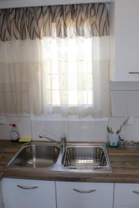 a sink in a kitchen with a window at Ateni House Garden in Agios Petros +32 photos