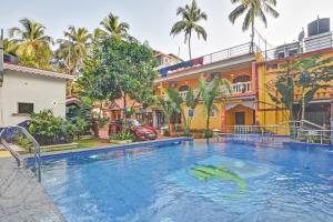 a large swimming pool in front of a building at Casa Salvador in Calangute