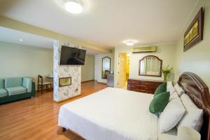 a bedroom with a bed and a living room at Hotel Britania San Borja in Lima +51 photos