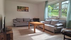 a living room with a couch and a table at Ferienhaus am Ring in Wimbach
