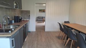 a kitchen with a counter and a table and chairs at Ferienhaus am Ring in Wimbach