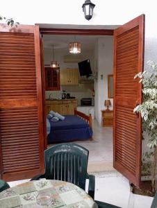 a room with a bed and a table and a kitchen at Akrata Golden Beach House 3 in Aíyira