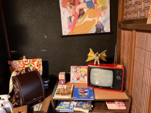 a table with a tv and other items on it at wagaranchi in Kumano