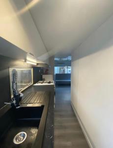 a kitchen with a sink and a counter top at Mobil-home dans un camping calme et familial chez César in Cambo-les-Bains