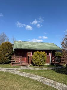 a small red house with a green roof at Trzy Domki Wysowa in Wysowa-Zdrój +19 photos