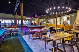 a restaurant with tables and chairs and a pool table at National Hotel Ganja in Ganja