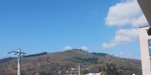 a view of a hill with a town on it at GH Apartments 2 in Gura Humorului +1 photo