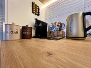 three coffee mugs sitting on top of a wooden counter at StarLux Residence - Because you deserve it! in Ćuprija