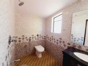 a bathroom with a toilet and a sink at Casa Salvador in Calangute +21 photos