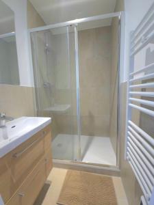 a shower with a glass door in a bathroom at La Tour d'Harfleur 2 in Caudebec-en-Caux +26 photos
