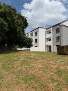 ein Mehrfamilienhaus mit einem großen Hof davor in der Unterkunft Elevare suites in Nelspruit